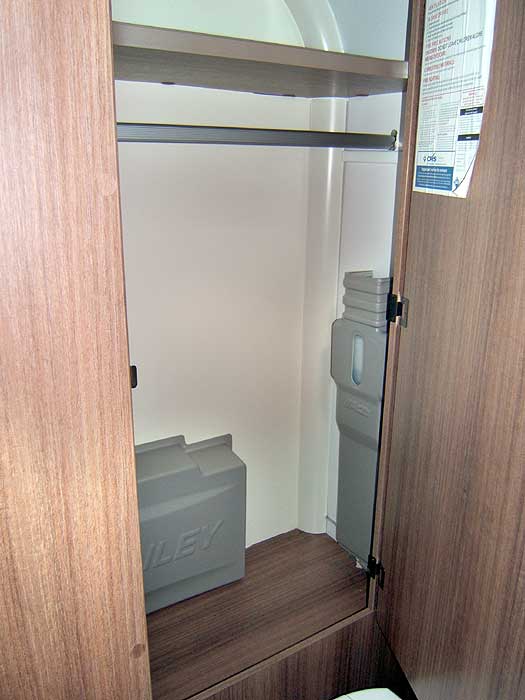 The large wardrobe with hanging rail in the washroom.